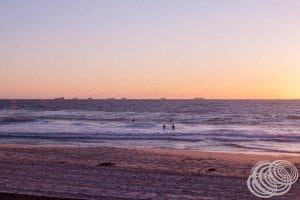 The sun setting over the ships off the coast from Cottesloe Beach