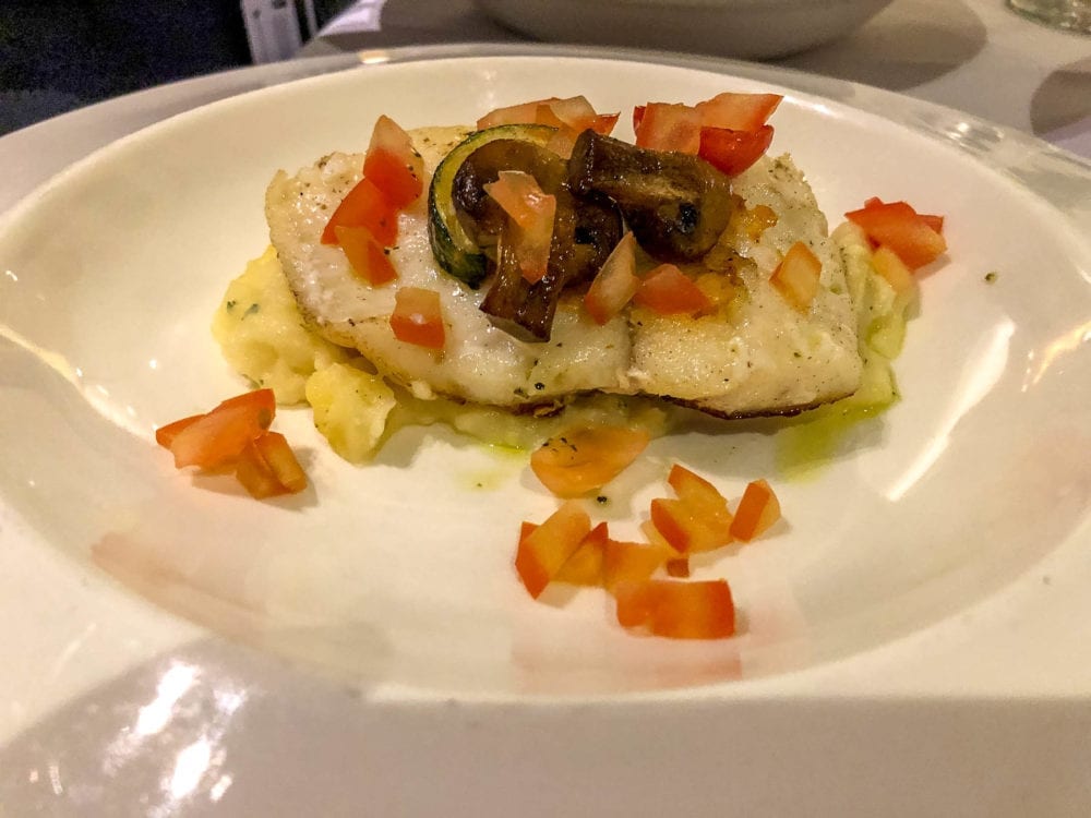 Angelo's Secondi Filetto di Merluzzo Spadellato. Pan-seared cod fillet  with potato puree, mushrooms, roast zucchini and cherry tomatoes.