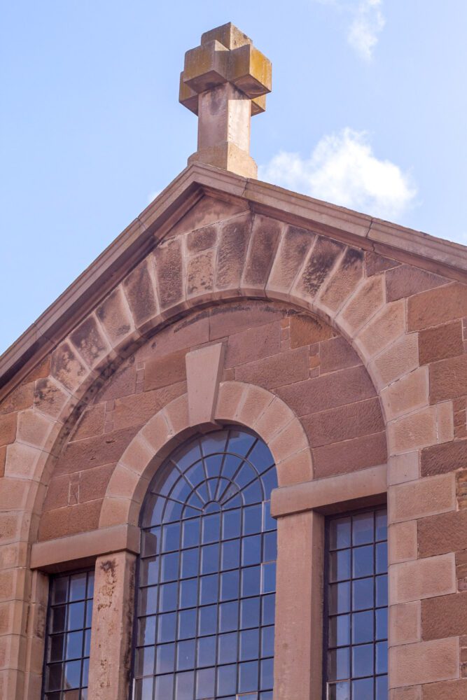 The glass windows and arched stonework of the Hobart Convict Penitentiary.